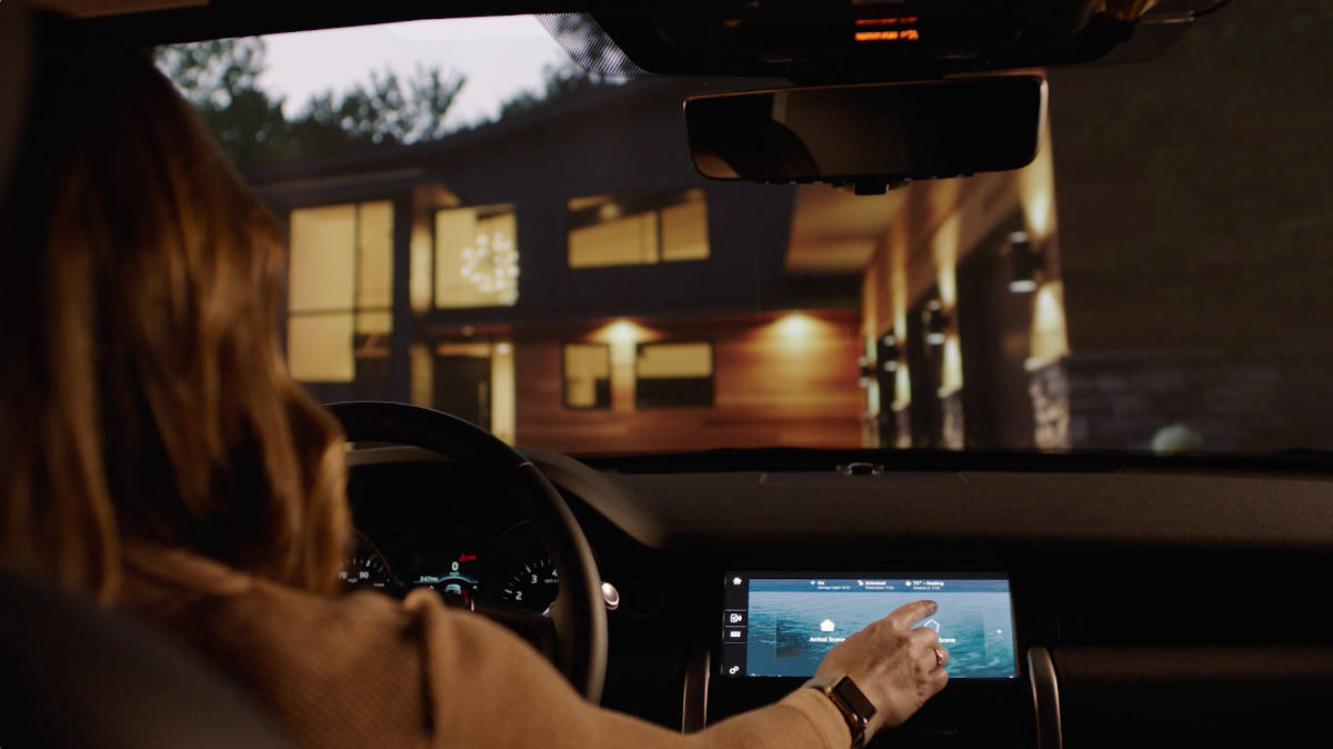 woman pressing tablet in her car